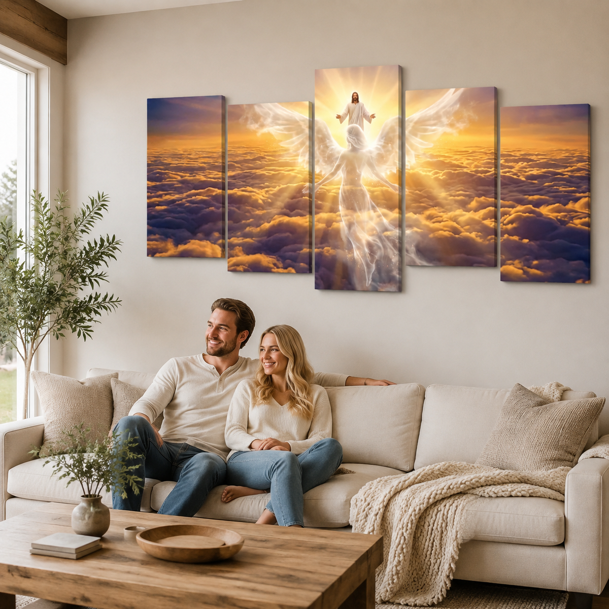 A five-panel canvas wall art set depicting a glowing angel figure above a sea of clouds at sunset, displayed on a beige wall above a living room sofa with a couple sitting underneath.
