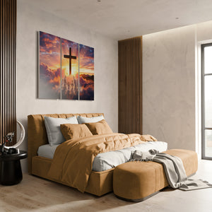 Modern bedroom with a bed, ottoman, and wall art of a cross and sunset.