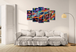 Colorful abstract Lamborghini Aventador wall art above a white sofa in a living room.