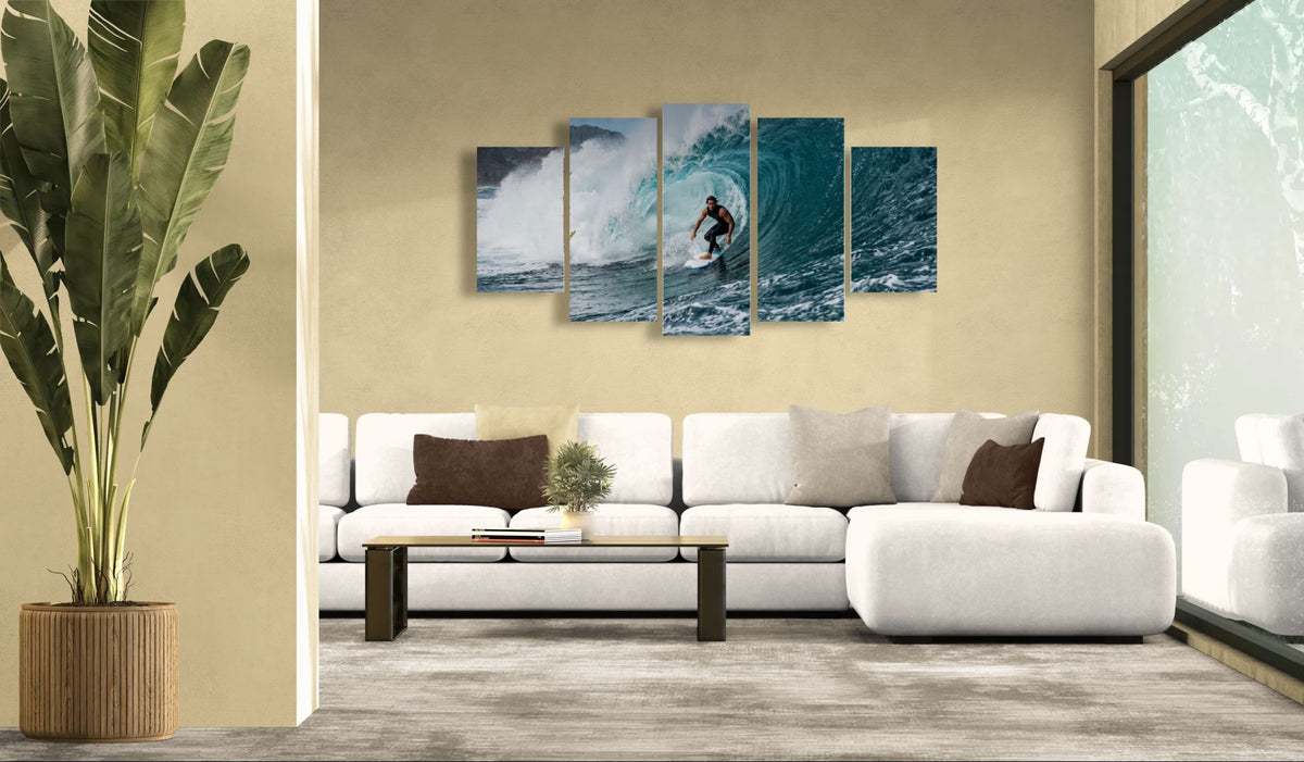 Modern living room with a white sofa, decorative pillows, and a large wall art piece depicting a surfer in the ocean.