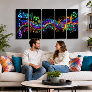 A 5-panel canvas wall art set depicting vibrant, colorful musical notes and staff lines flowing across a black background, displayed on a wall above a white sofa with a couple sitting on it in a modern living room setting.