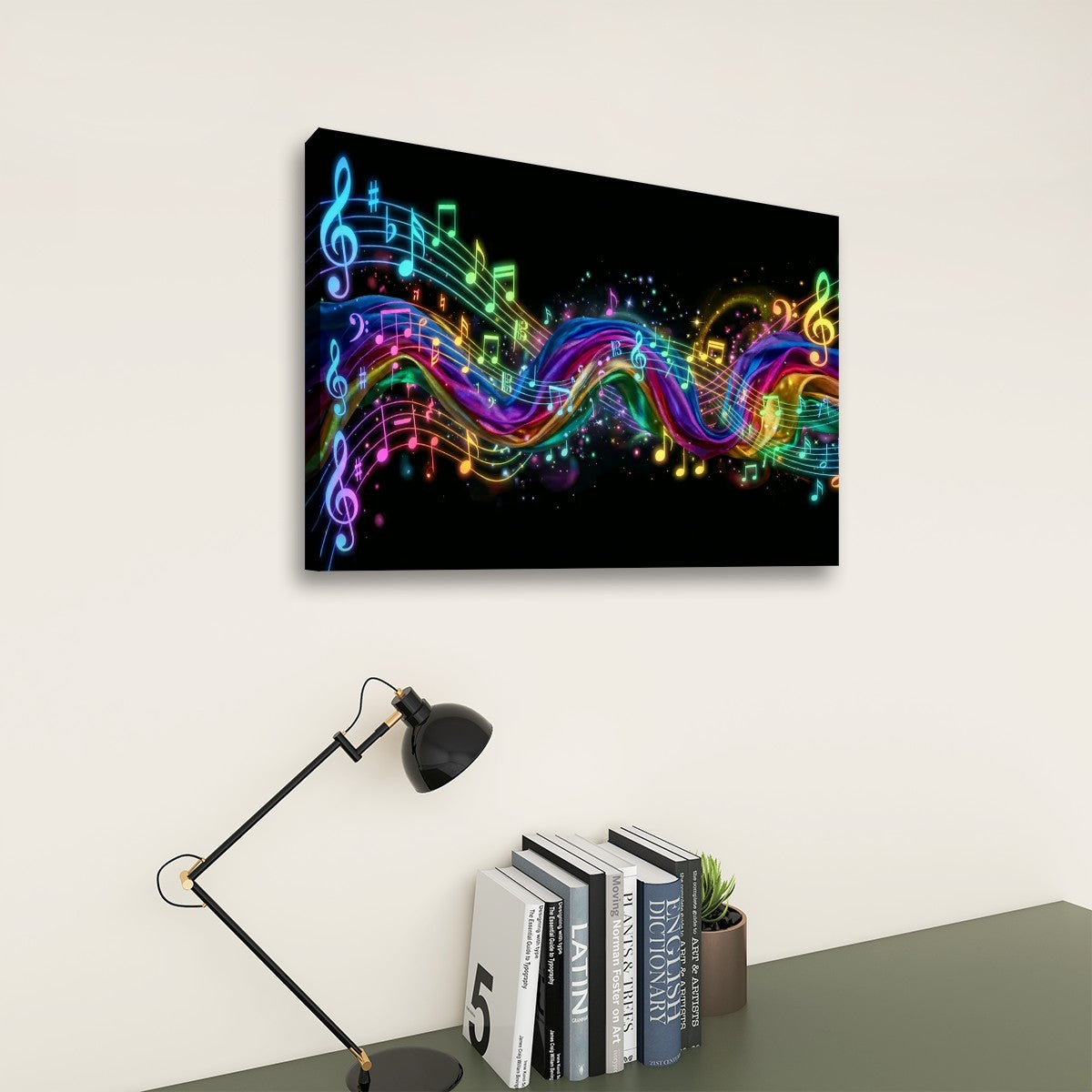 A rectangular wall art print showing a black background with glowing multicolored musical notes and treble clefs, displayed above a desk with books, a small plant, and a black desk lamp in a room setting.