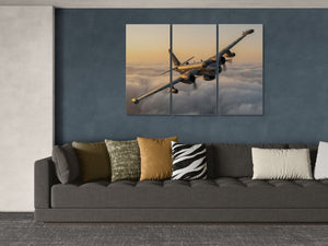 Triptych wall art of a P2V airplane flying over clouds above a gray sofa with patterned cushions.
