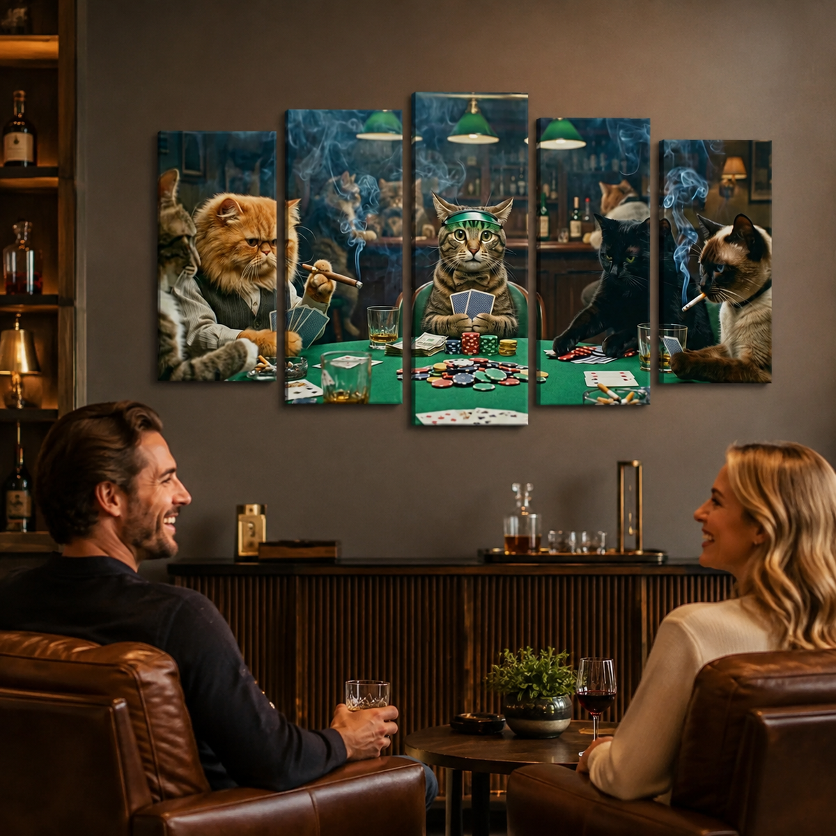 A 5-panel canvas wall art set depicting anthropomorphic cats playing poker, displayed on a dark gray wall in a modern living room setting above a bar counter, with a man and woman seated in brown leather armchairs looking at the artwork.