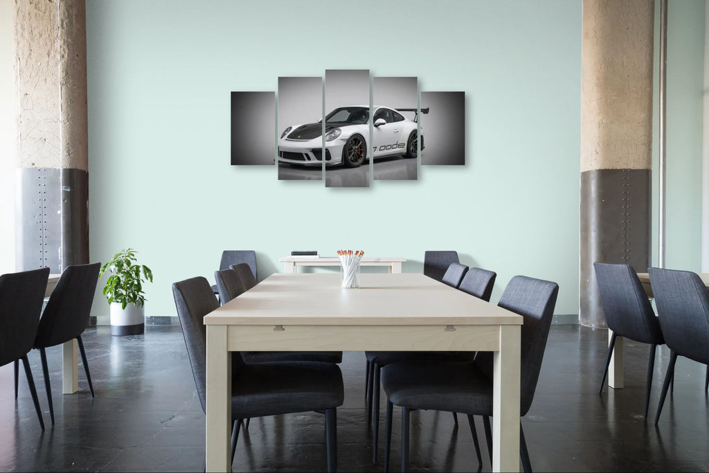 Dining room with a large table and chairs, featuring a wall art of a porsche 911 gt3 991.2 generation car.