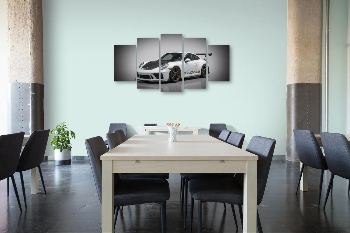 Dining room with a large table and chairs, featuring a wall art of a porsche 911 gt3 991.2 generation car.