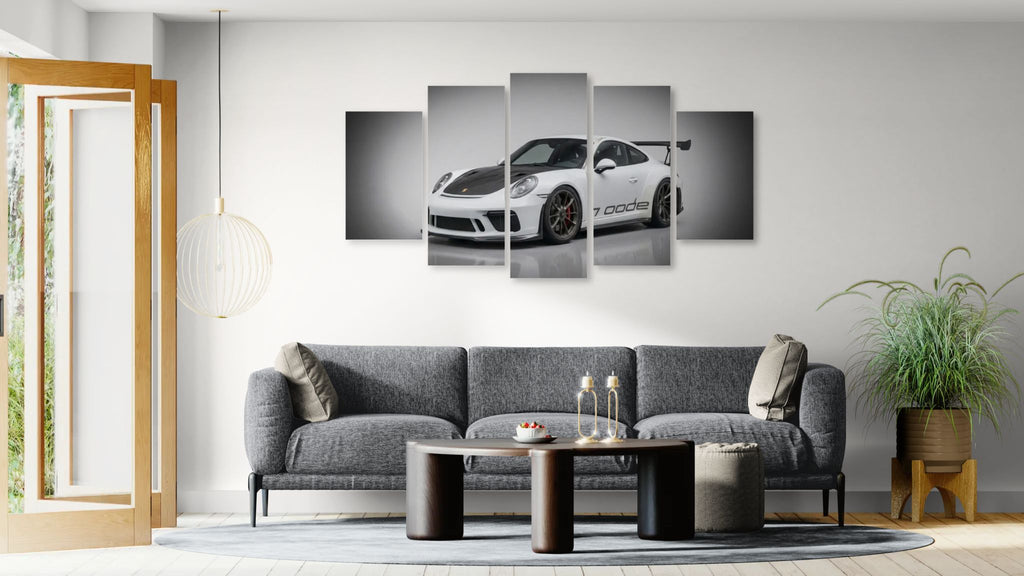 Living room with a gray sofa, coffee table, and wall art featuring a porsche 911 gt3 991.2 generation car.