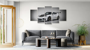 Living room with a gray sofa, coffee table, and wall art featuring a porsche 911 gt3 991.2 generation car.