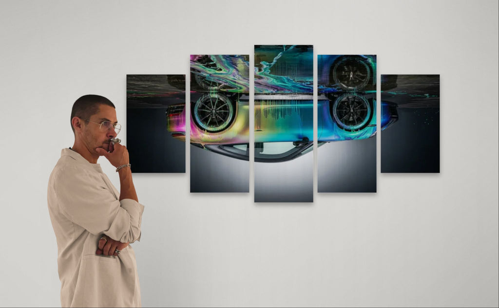 Man looking at a set of five colorful UPSIDE DOWN LOL Porsche 911 Sportscar wheel wall art on a white wall.