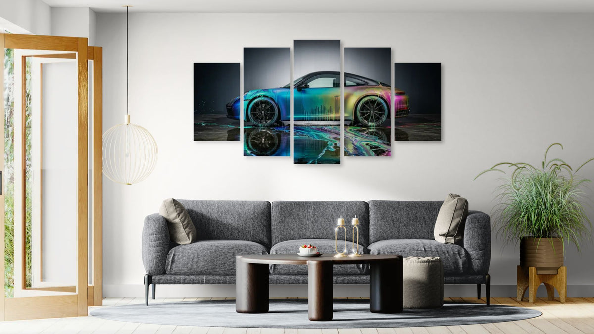 Living room with a gray sofa, coffee table, and wall art of a Porsche 911 Sportscar .