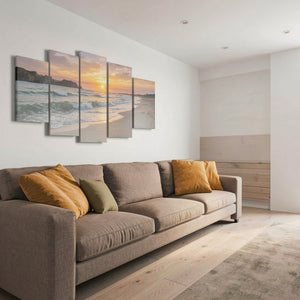 Modern living room with a gray sofa, yellow pillows, and beach-themed wall art.