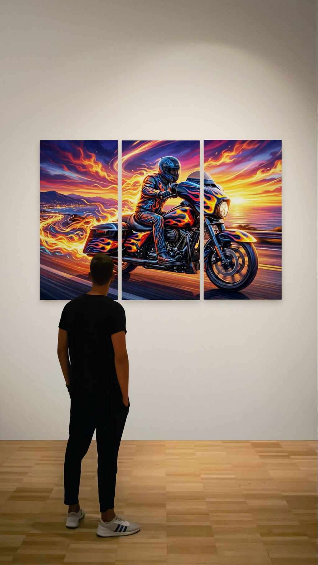 Person looking at a triptych painting of a Harley-Davidson Street Glide motorcycle rider on a beach with a sunset.