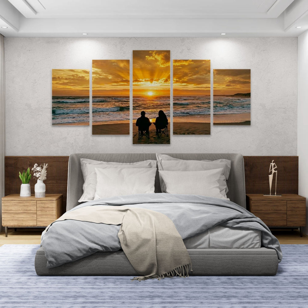 Bedroom with a large bed and wall art of a sunset over the ocean.