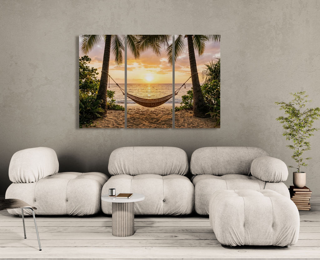 Modern living room with a large sofa and a wall art depicting a tropical sunset with a hammock.