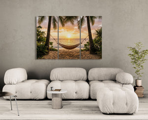 Modern living room with a large sofa and a wall art depicting a tropical sunset with a hammock.