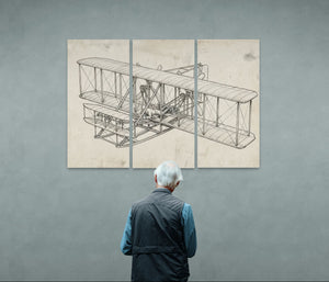 Man looking at a large vintage Wright Brothers airplane blueprint on a wall